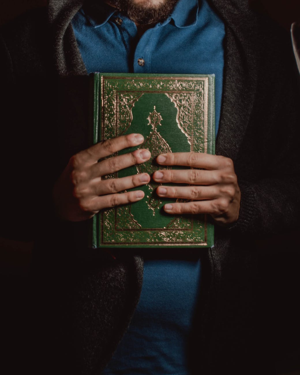 muslim man with religious book in hands