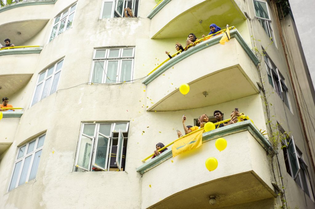people watching from a balcony of building