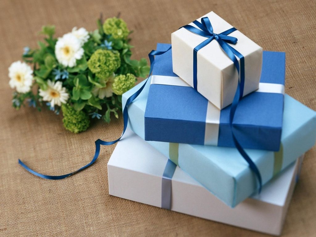 several gift boxes near the white flowers
