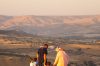 unrecognizable muslim family standing on hilltop and admiring highland view